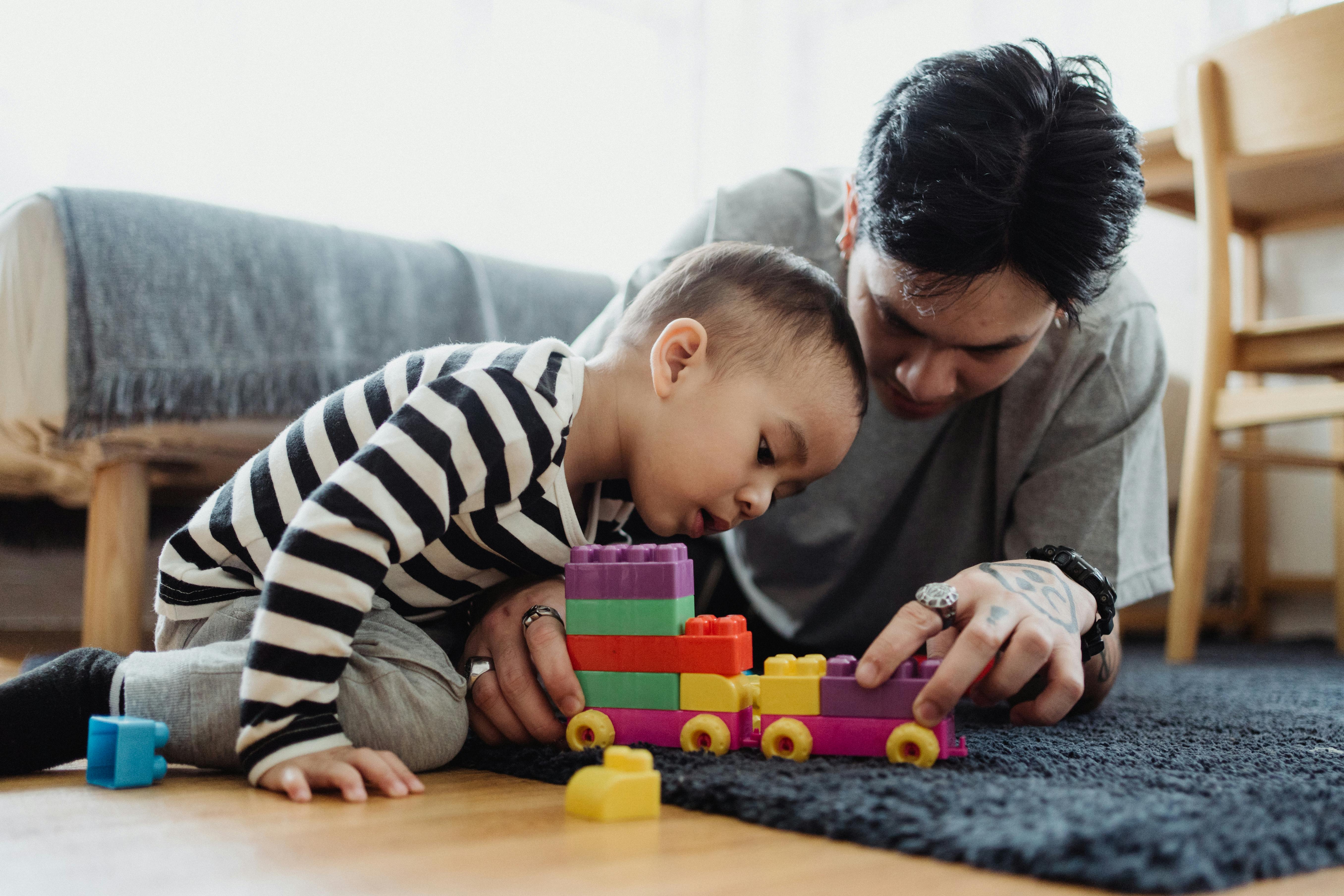 Father and child playing with toys.